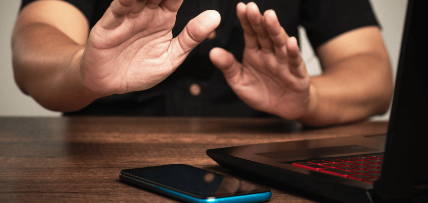 Person avoiding smartphone, focus on hands.