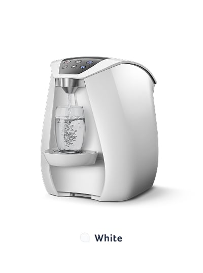 White water purifier dispensing water into glass