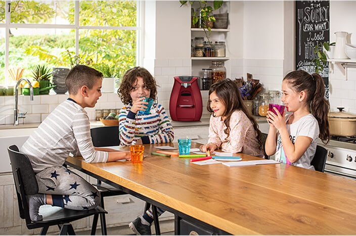 Children playing game at kitchen table.