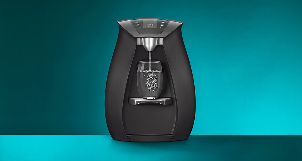 Stylish water cooler dispensing glass of water.