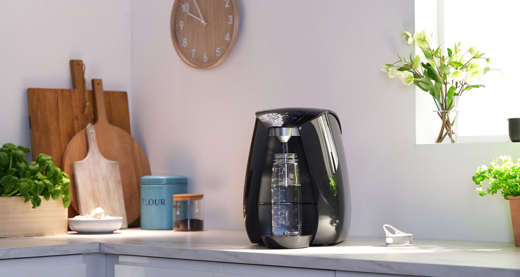 Soda maker on kitchen countertop with decor.
