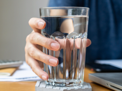 Hand holding a glass of water